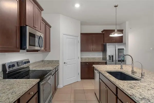 a kitchen that has a sink and a stove