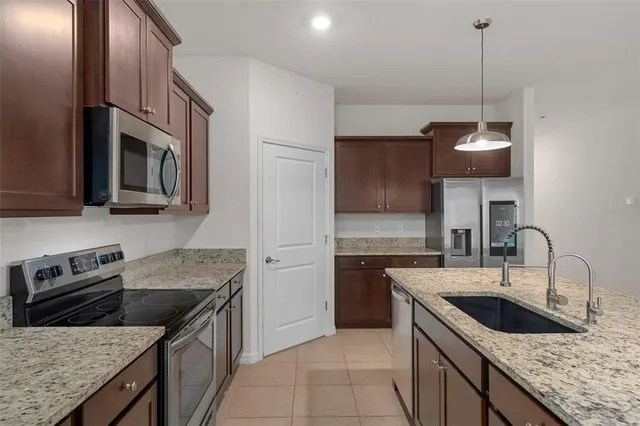 a kitchen that has a sink and a stove