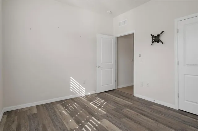 a view of room with wooden floor and closet