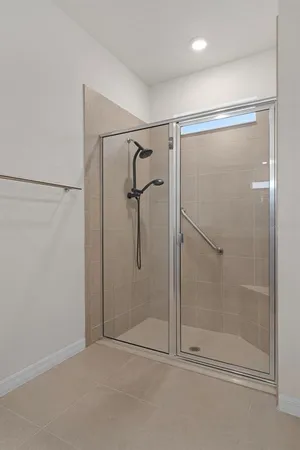 a bathroom with a glass shower door