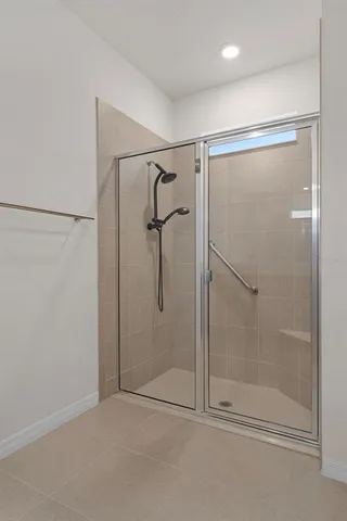 a bathroom with a glass shower door