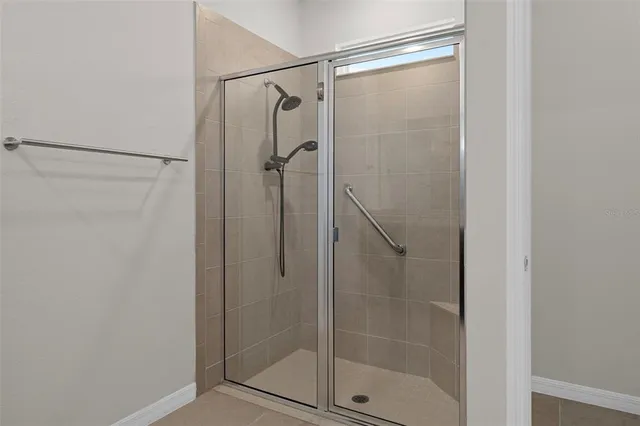 a bathroom with a glass shower door