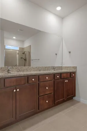 a bathroom with a granite countertop sink and mirror