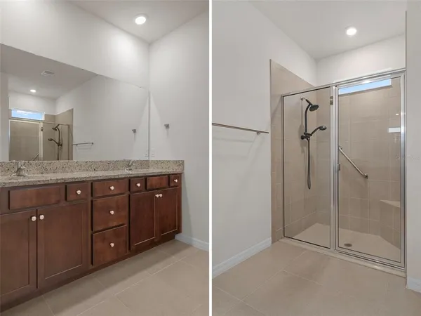 a bathroom with a granite countertop sink mirror and shower
