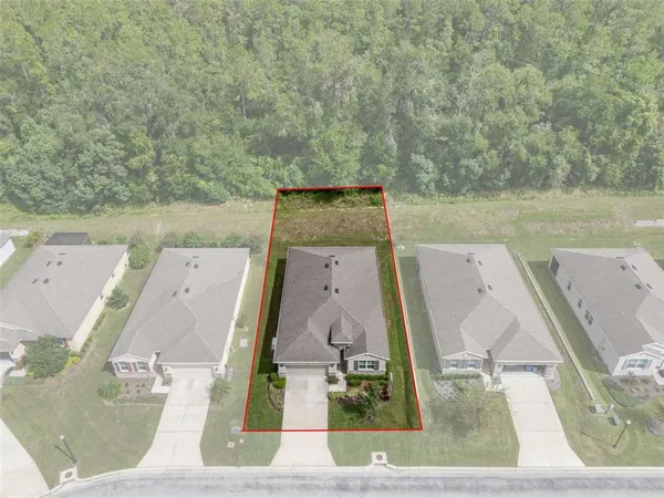 an aerial view of a house with outdoor space