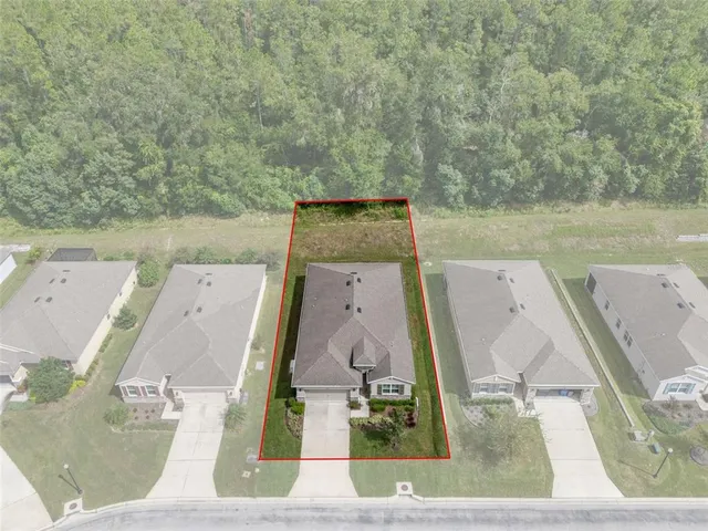 an aerial view of a house with outdoor space
