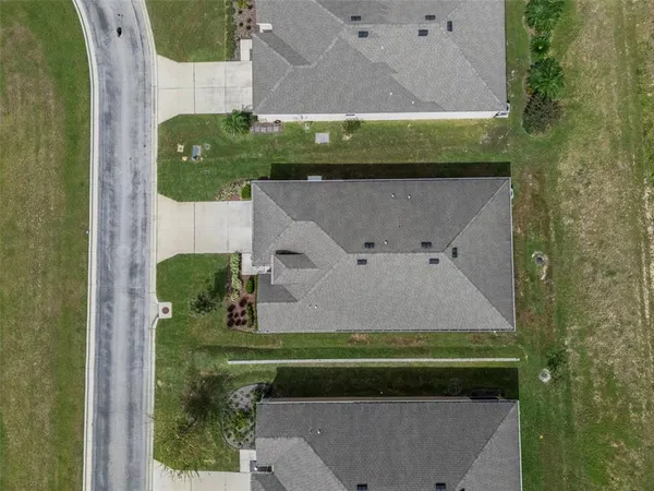 an aerial view of a house with a yard