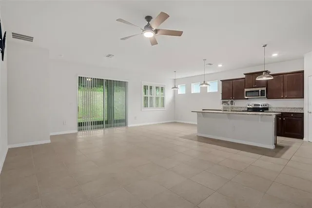 a view of kitchen with cabinets microwave and stove
