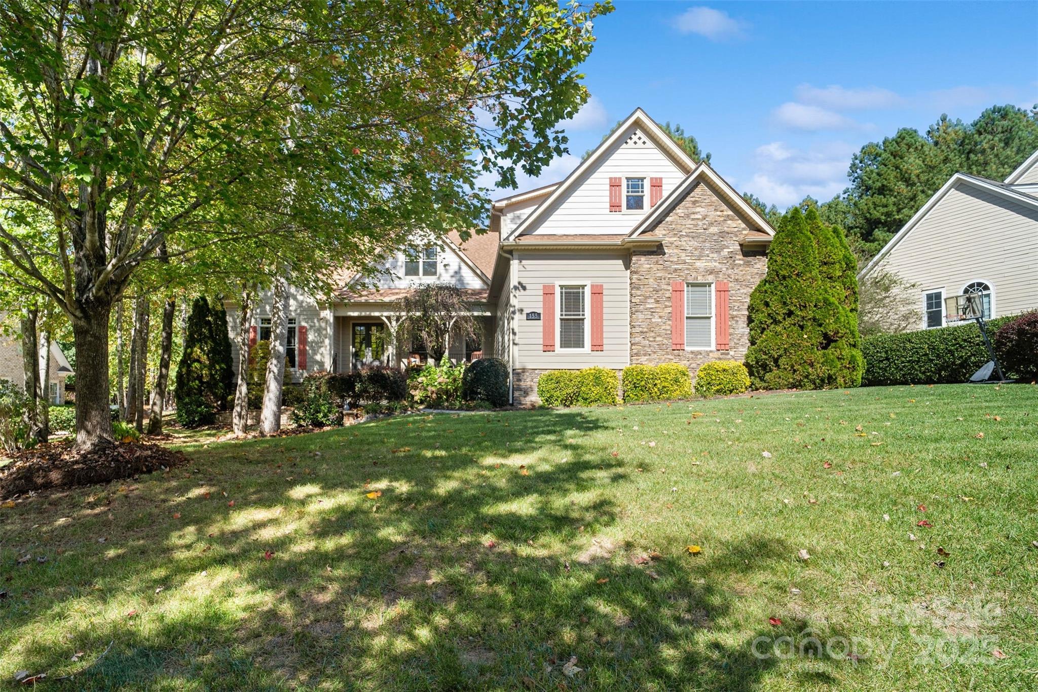a front view of a house with yard and green space