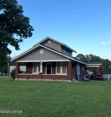 a front view of a house with a yard table and chairs