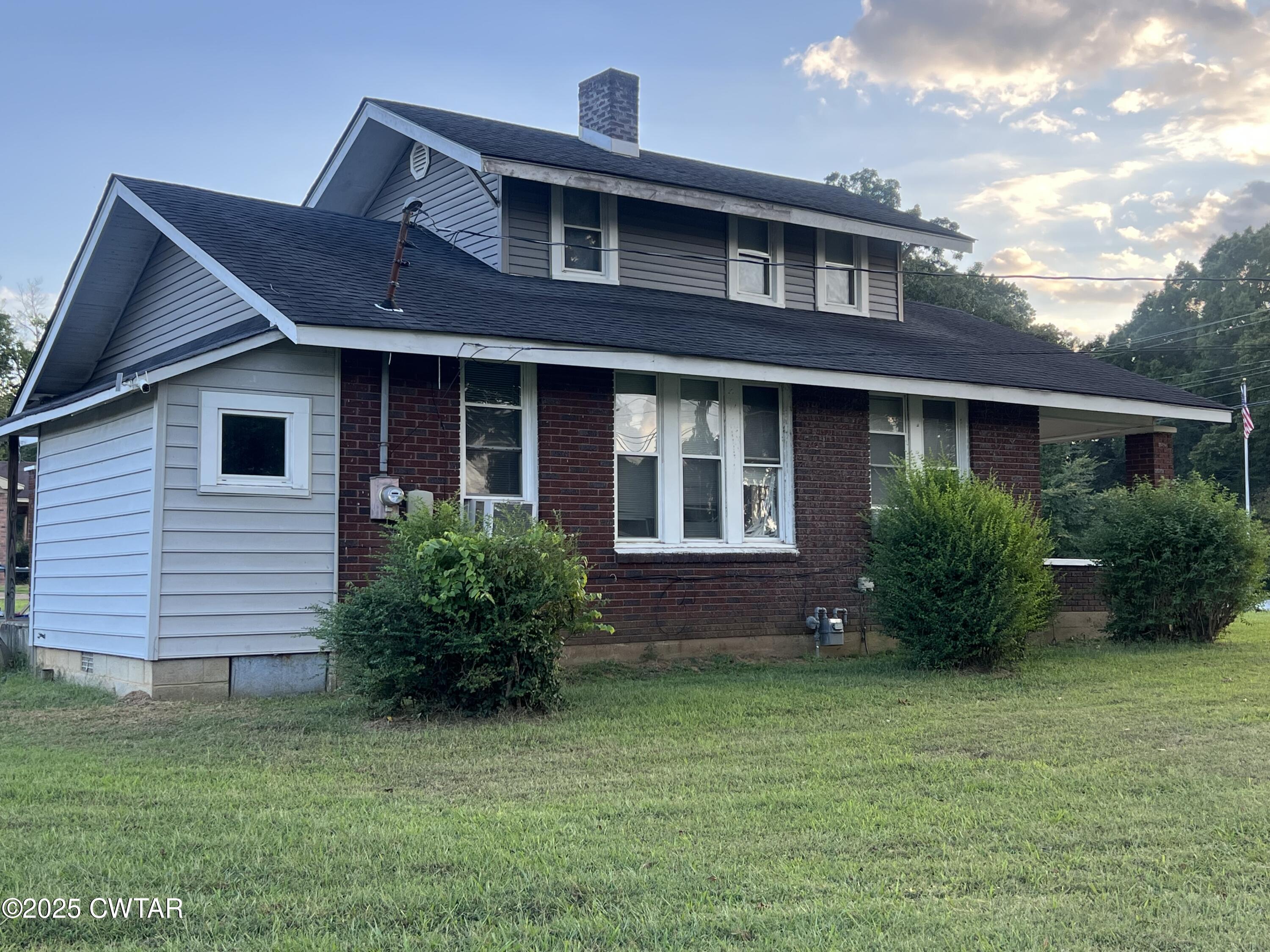 1464 Riverside Drive Jackson, TN 38301 - Photo 3 of 3 a front view of a house with a garden