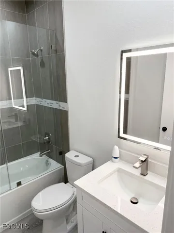a bathroom with a toilet a sink and bathtub