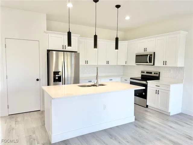 a kitchen with refrigerator and cabinets