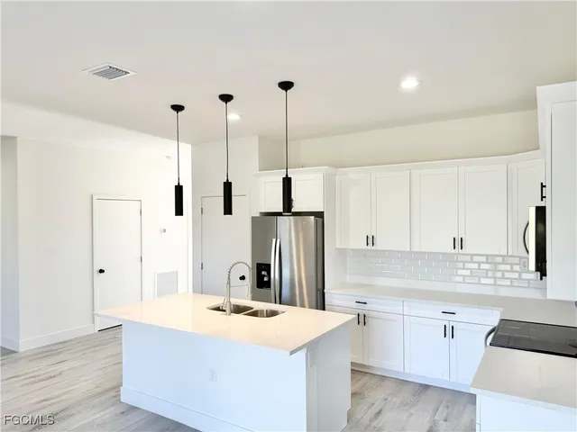 a kitchen with a sink and cabinets