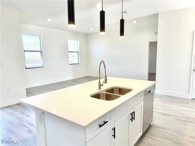 a view of a kitchen with a sink and a window