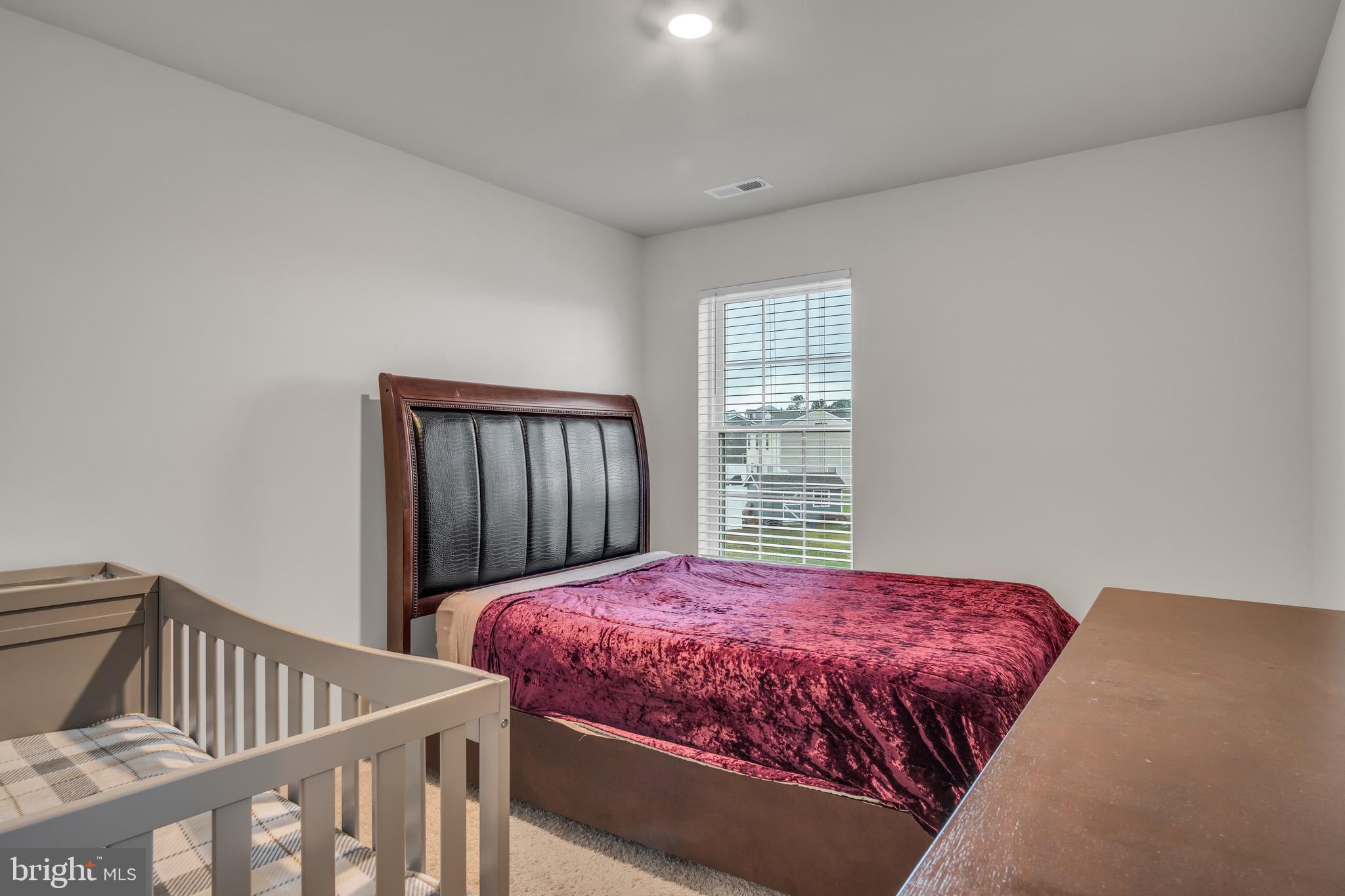 18 Smokehouse Road Carlisle, PA 17013 - Photo 21 of 33 a bedroom with a bed and wooden floor
