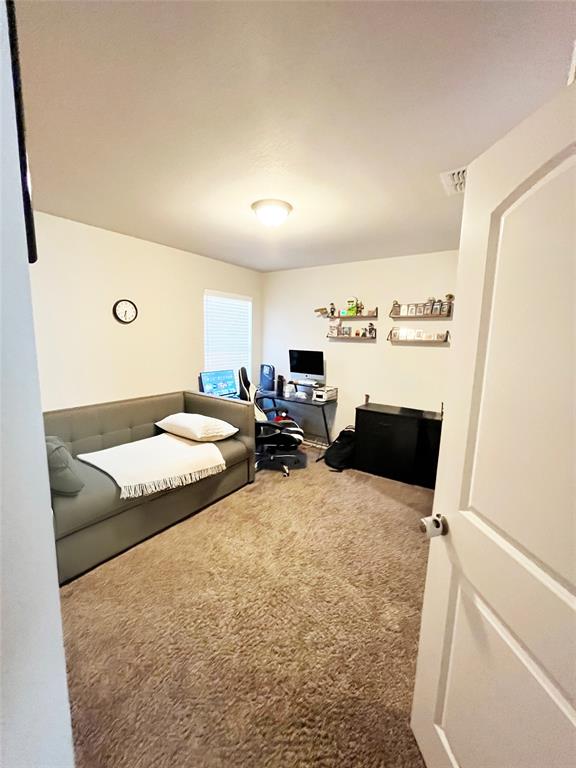 3128 Risinger Road Lorena, TX 76655 - Photo 10 of 14 a bedroom with a bed and a flat screen tv