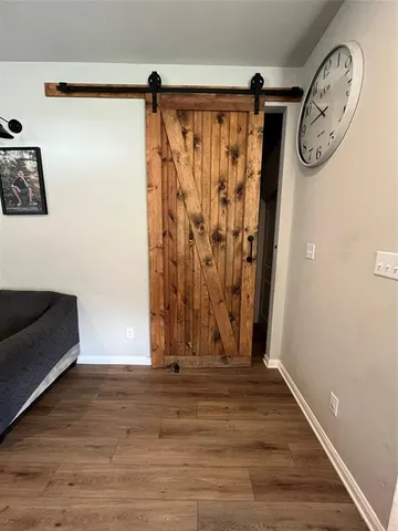 a view of walk in closet with wooden floor