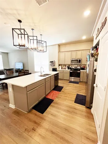 a kitchen with stainless steel appliances a sink and cabinets