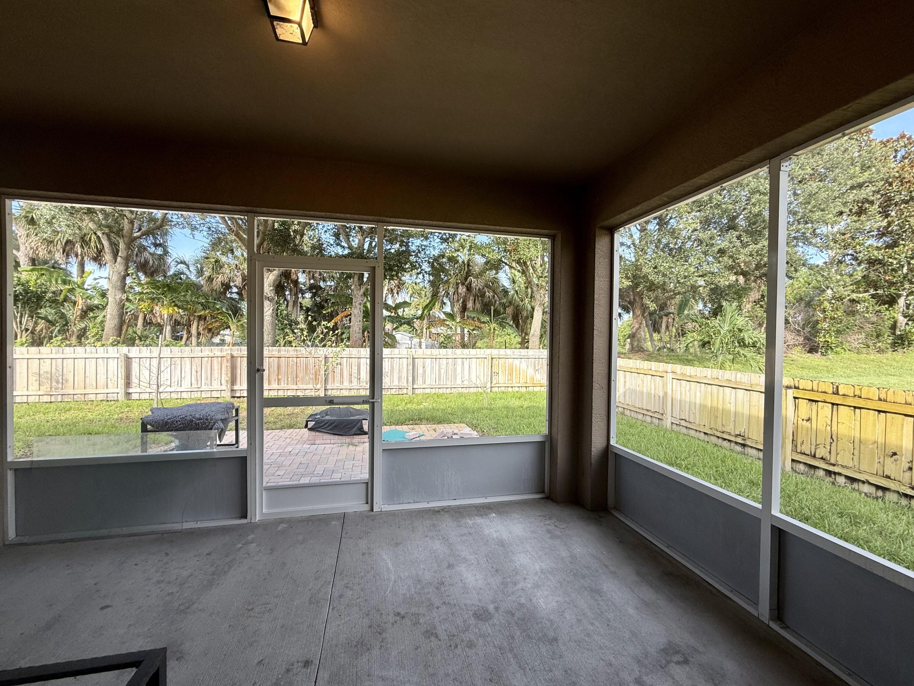 5997 Ridge Lake Circle Vero Beach, FL 32967 - Photo 11 of 14 a view of an empty room with large windows