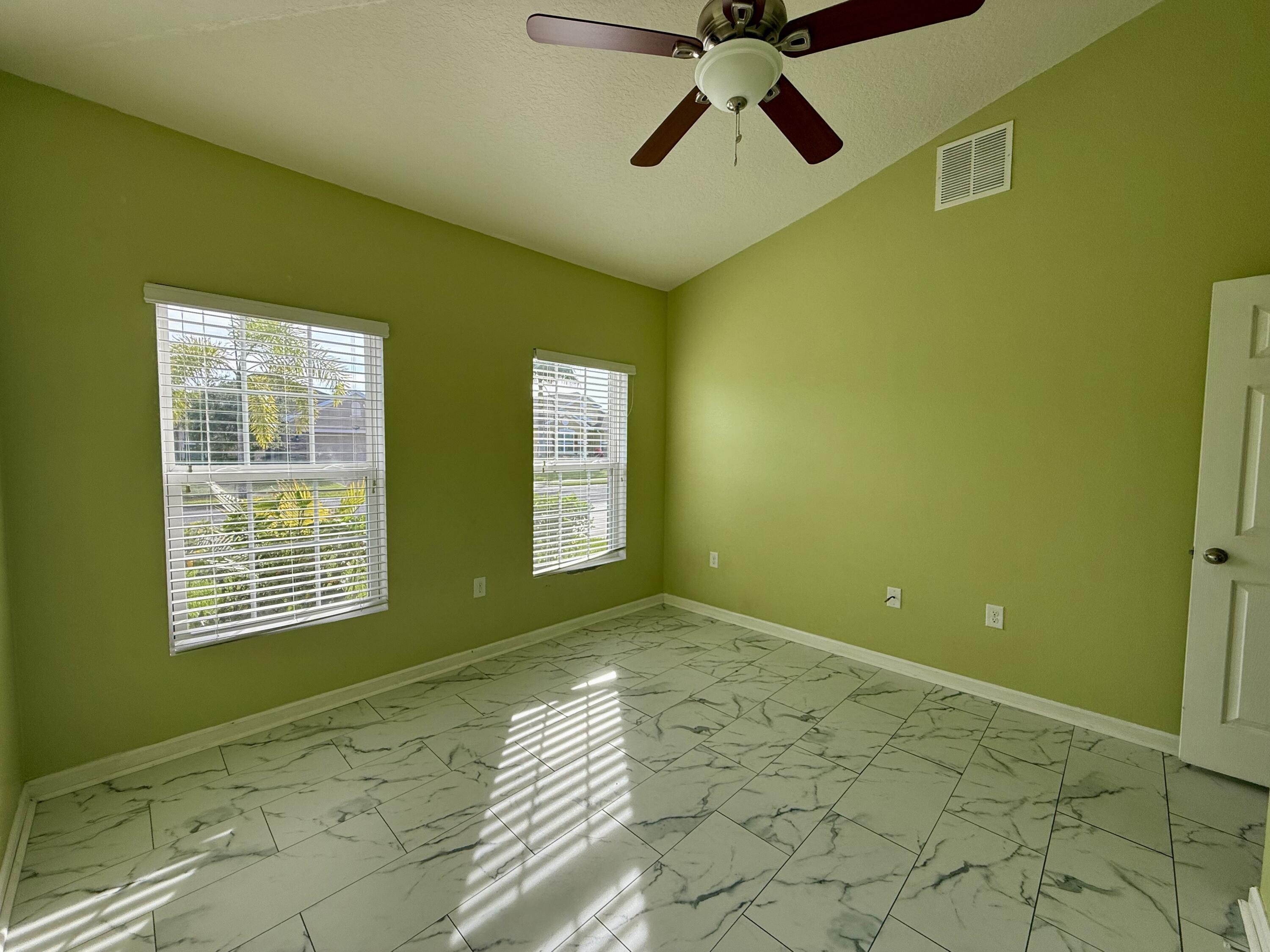 5997 Ridge Lake Circle Vero Beach, FL 32967 - Photo 8 of 14 a view of an empty room with a window and a fireplace