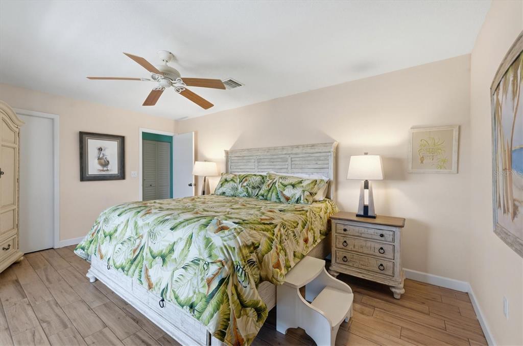 2729 North Beach Road, Unit 211 Englewood, FL 34223 - Photo 25 of 51 a bedroom with a bed and wooden floor