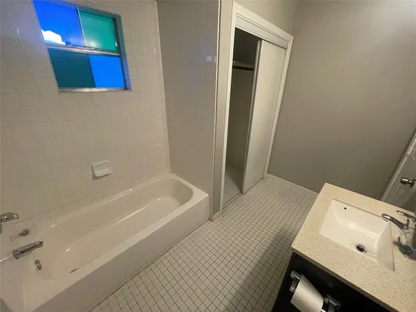 a bathroom with a bathtub and shower