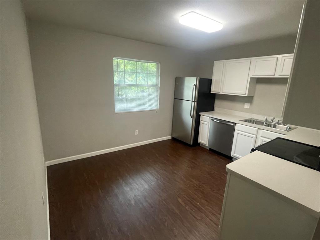 701 Elsbeth Street, Unit 201 Dallas, TX 75208 - Photo 6 of 14 a kitchen with a refrigerator and a stove top oven
