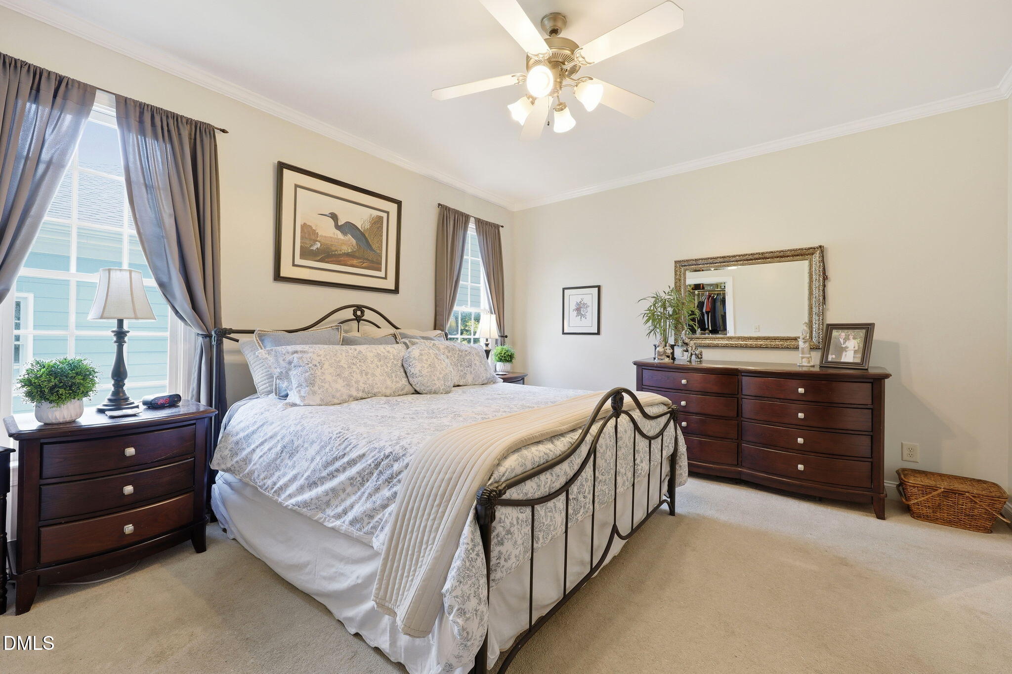 7040 Dayton Ridge Drive Apex, NC 27539 - Photo 19 of 38 a bedroom with a bed and a mirror on the dresser