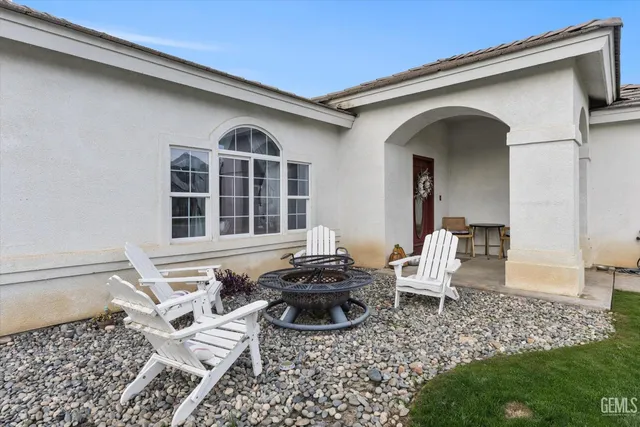 a view of a porch with table and chairs