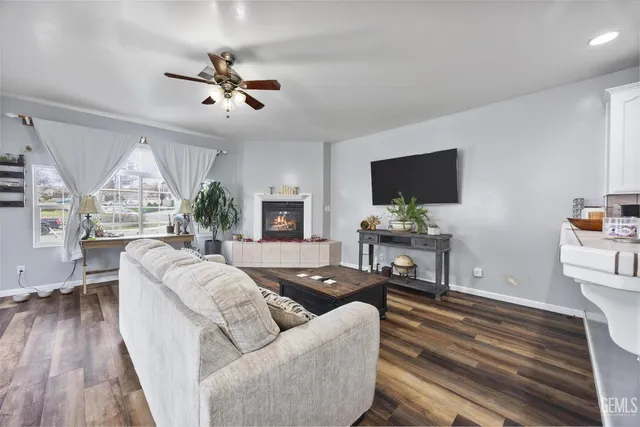 a living room with furniture a fireplace and a chandelier