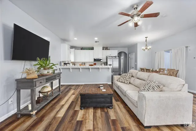 a kitchen with a refrigerator sink and cabinets