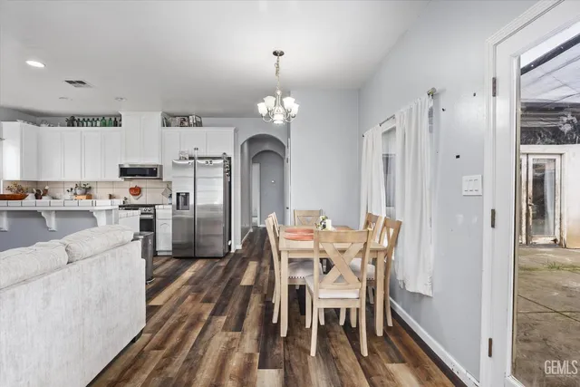 a kitchen with granite countertop stainless steel appliances and white cabinets