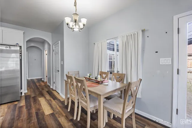 a kitchen with stainless steel appliances granite countertop a sink and white cabinets
