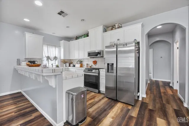 a kitchen with stainless steel appliances granite countertop a stove and a sink