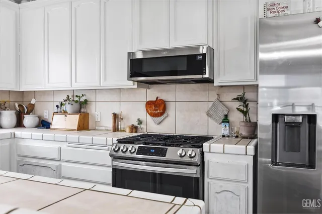 a view of a hallway with wooden floor and a bathroom