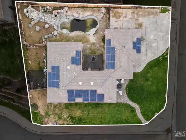 an aerial view of a house with a yard and a fountain