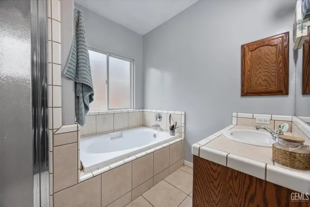 an empty room with window and ceiling fan