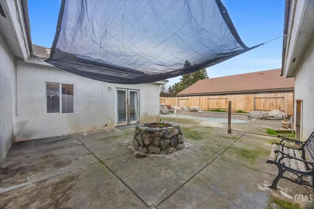 a swimming pool with outdoor seating and yard