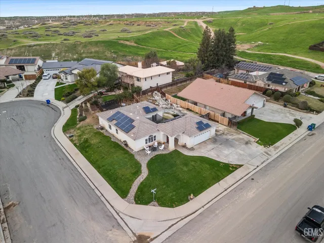 an aerial view of a city with lots of residential buildings ocean and mountain view in back