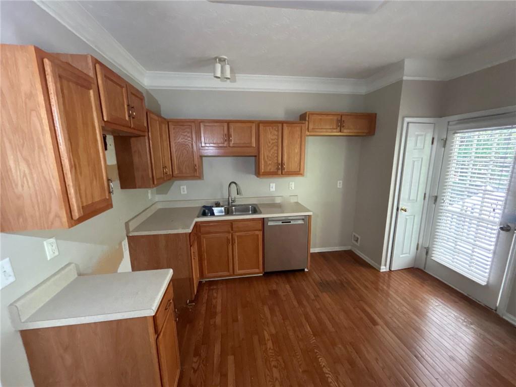 95 Luke Drive Dallas, GA 30132 - Photo 4 of 15 a kitchen with stainless steel appliances kitchen island granite countertop wooden floors and sink