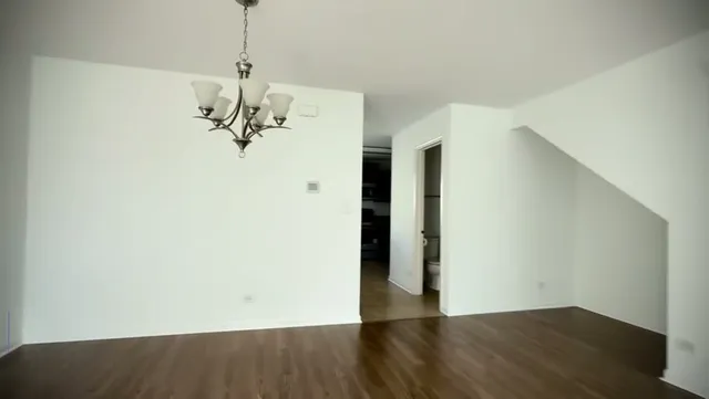 a view of a room with wooden floor and carpet