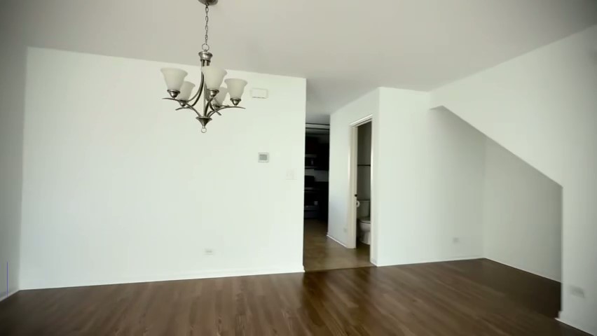 1192 Alta Vista Drive, Unit 1192 Pingree Grove, IL 60140 - Photo 3 of 8 a view of a room with wooden floor and carpet