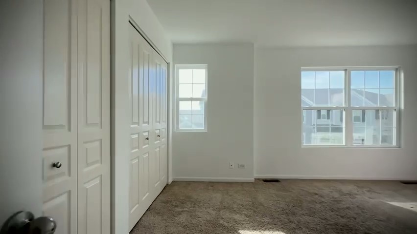 1192 Alta Vista Drive, Unit 1192 Pingree Grove, IL 60140 - Photo 7 of 8 an empty room with windows