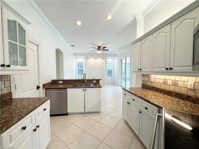 a view of a kitchen with stainless steel appliances granite countertop a refrigerator and a sink