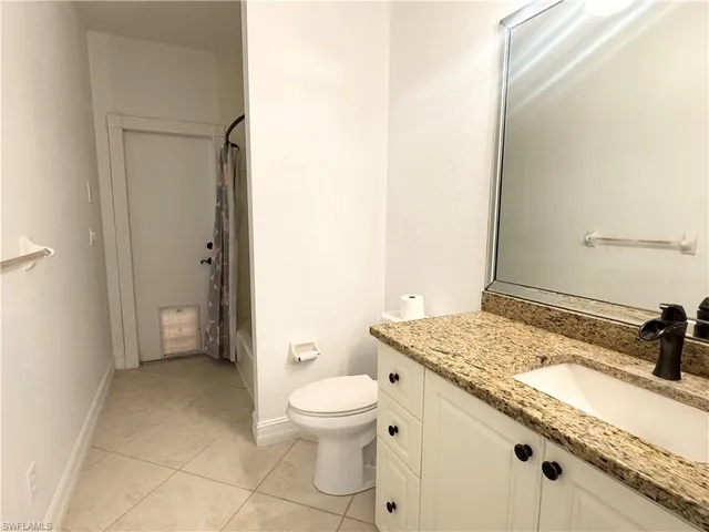 a view of a porch with a floor to ceiling window and wooden fence