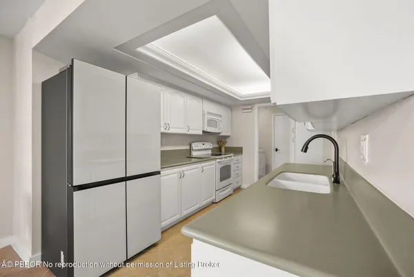 a kitchen with stainless steel appliances granite countertop a sink a stove and a refrigerator