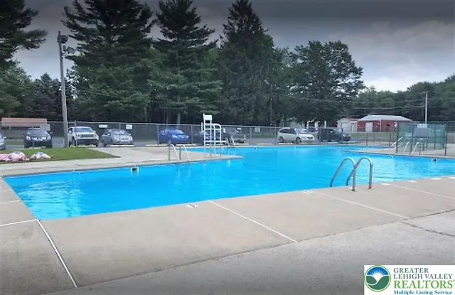 a view of a swimming pool with an outdoor seating