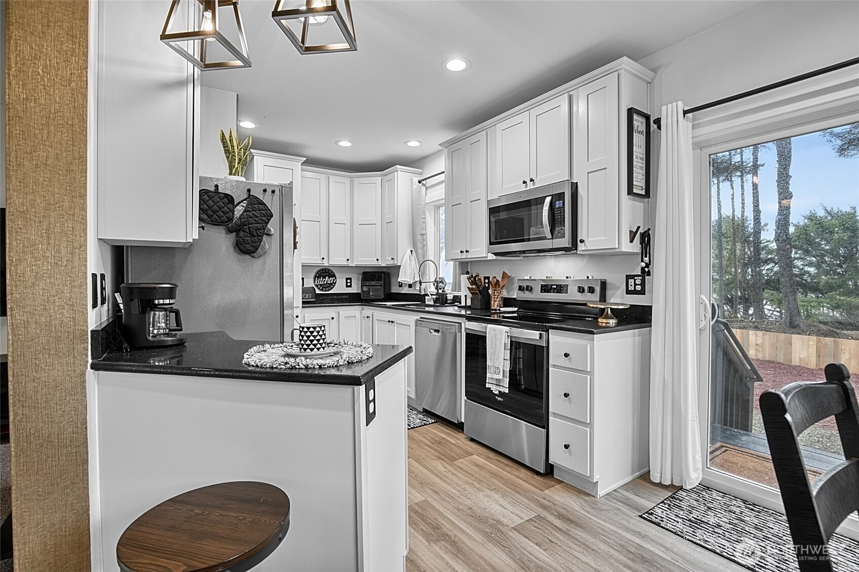 47295 State Route 109 Moclips, WA 98562 - Photo 12 of 40 a kitchen with stainless steel appliances granite countertop a sink stove microwave and refrigerator