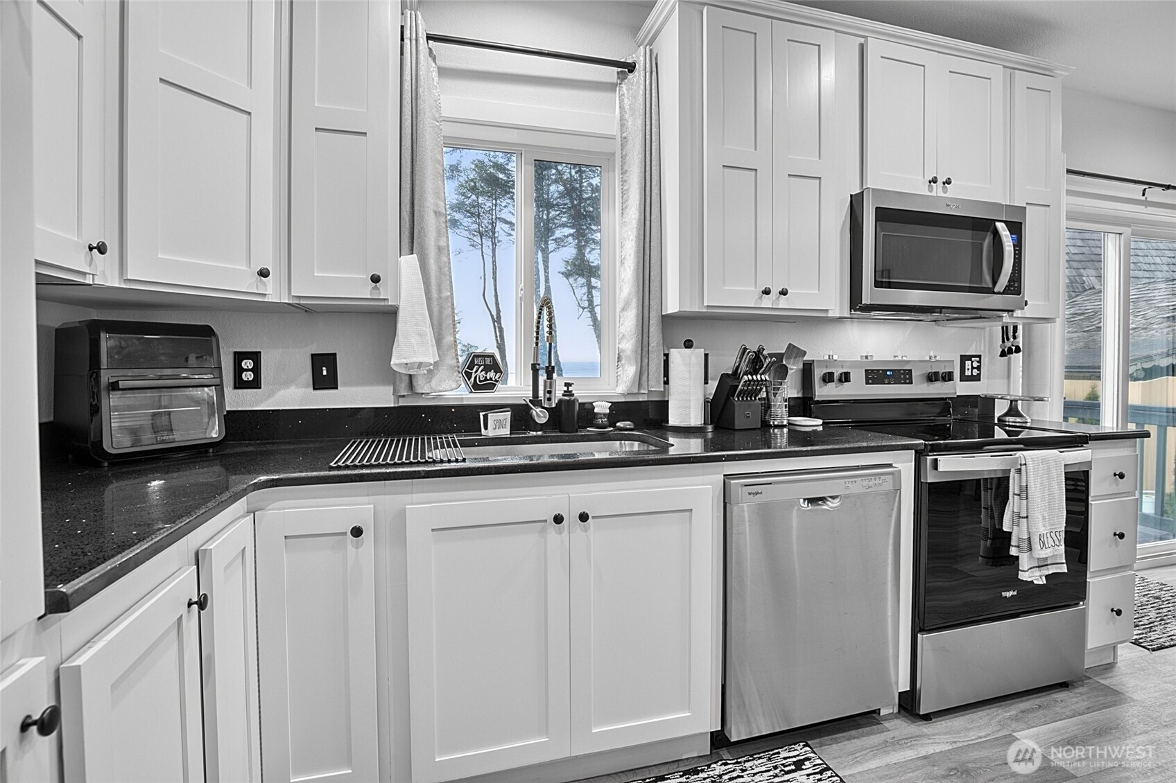 47295 State Route 109 Moclips, WA 98562 - Photo 17 of 40 a kitchen with white cabinets and white appliances